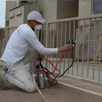 Commercial painting services on a metal fence