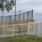 Commercial painting services on a metal fence